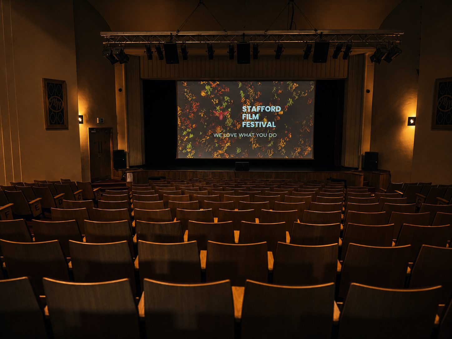 The Mitchell Arts Centre auditorium seen from the stage, raked seating and a balcony at the rear